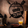 Black retro BBQ zone wall decor featuring a silhouette of crossed BBQ tools and the text BBQ ZONE on a rustic wooden surface.