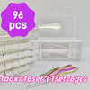 A box of 96 pieces of elegant spiral cake candles, packaged in a clear container and displayed next to stacked white boxes.