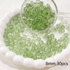 A clear glass dropper shows small green spacer beads scattered on a white dish.