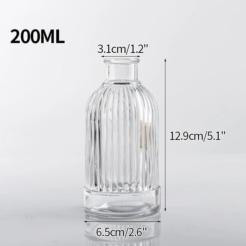 A clear glass vase with ribbed texture, measuring 12.9cm tall and 6.5cm wide.
