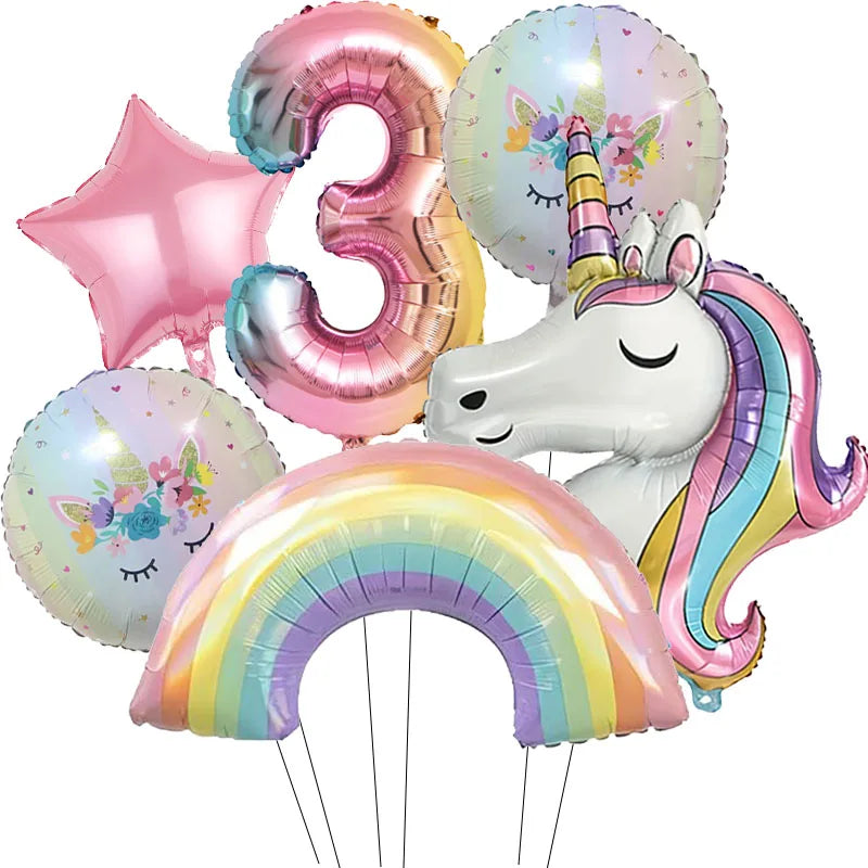 A cluster of pink and iridescent foil balloons shaped like the number three and a unicorn head