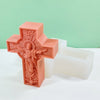 A pink silicone mold shaped like a religious Jesus cross, used for crafting and decorating.