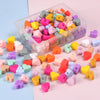 A clear plastic container filled with colorful silicone heart beads for DIY jewelry making