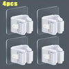 Four white wall mounted holders for storing mops and brooms.