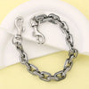A silver and dark metal two-tone chain necklace with a pendant displayed on a white background.