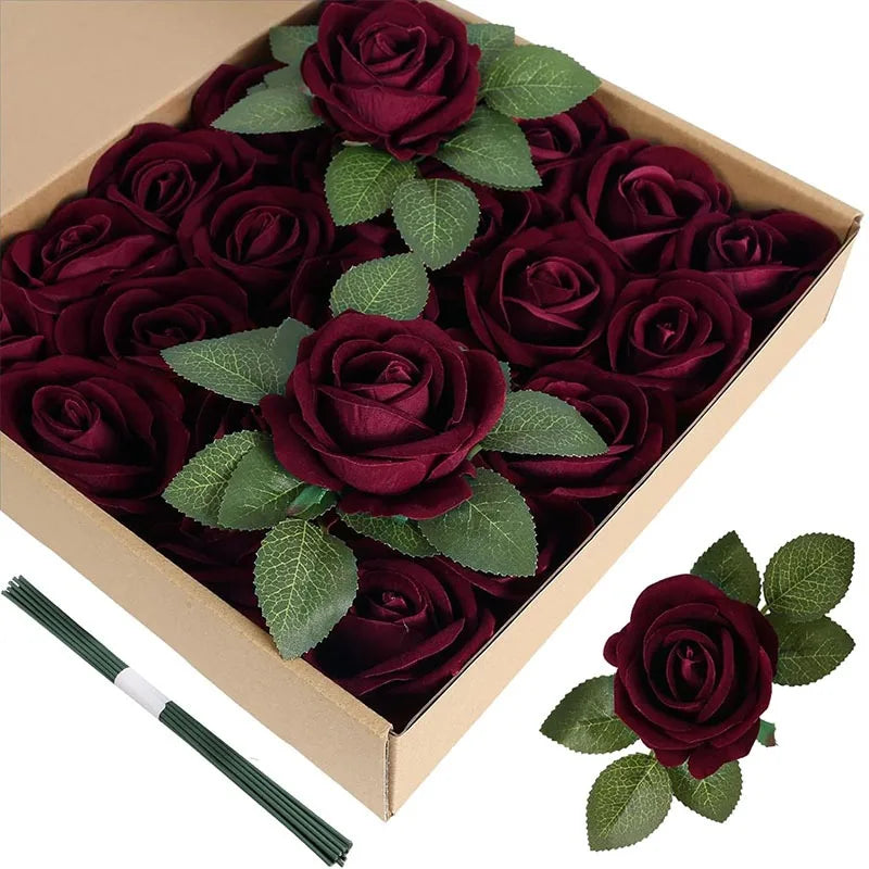 A box filled with 50 artificial deep red velvet roses and green leaves.