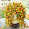 A dense arrangement of orange and yellow faux silk flowers used for outdoor decor.