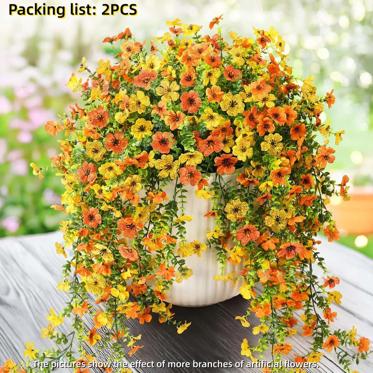 A dense arrangement of orange and yellow faux silk flowers used for outdoor decor.