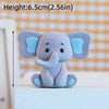 A small, gray cartoon elephant figure with light blue ears sitting on a white surface.