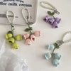 Handmade pearl chain orchid key rings featuring small crocheted flowers in shades of green and pink.