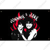 A black and white illustration of two people with dark hair and glasses, surrounded by red flames, with the text JOHNNIE & JA