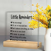 An acrylic desk plaque with a motivational sign listing affirmations like You are enough and Be kinder to yourself.