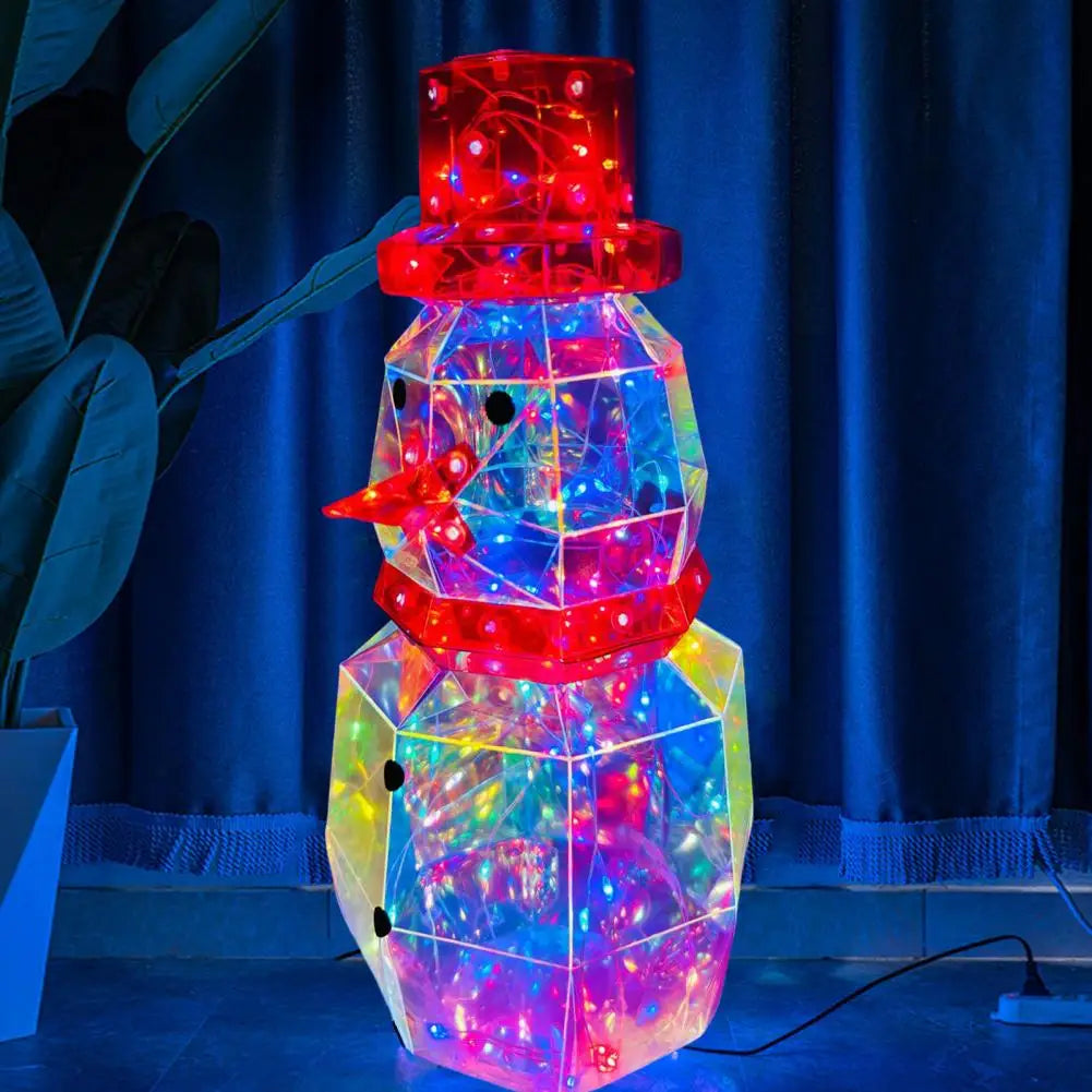 A colorful prismatic LED snowman decoration with glowing lights standing in front of a blue curtain.