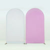 A pair of stretchable arch backdrop covers, one white and one pink, displayed against a light background.
