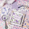 A vintage paper pack featuring purple and green floral patterns for junk journals and scrapbooking.