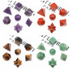 A collection of seven geometric crystals in various colors including purple, red, and green.