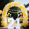 A yellow and white balloon arch decorated with a large light-up marquee number 21 for an event.