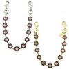 A delicate gold-toned chain necklace featuring pink and black floral charms.