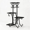 A black metal corner plant stand with four tiers for indoor and outdoor use.