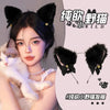 A woman models a black cat ear headband and a black velvet flower accessory with a white kitten.