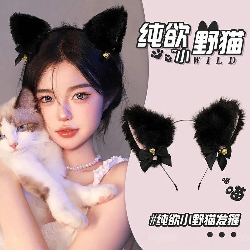 A woman models a black cat ear headband and a black velvet flower accessory with a white kitten.