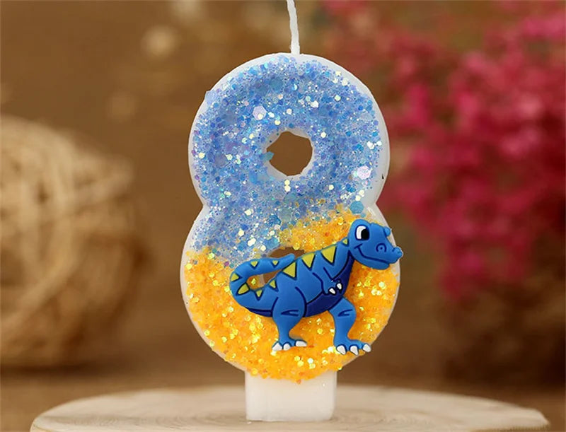 A birthday candle shaped like the number 8, featuring a blue glitter top and an orange base with a small blue dinosaur figure