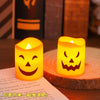 A set of six glowing orange Halloween LED candles sitting on a wooden surface.
