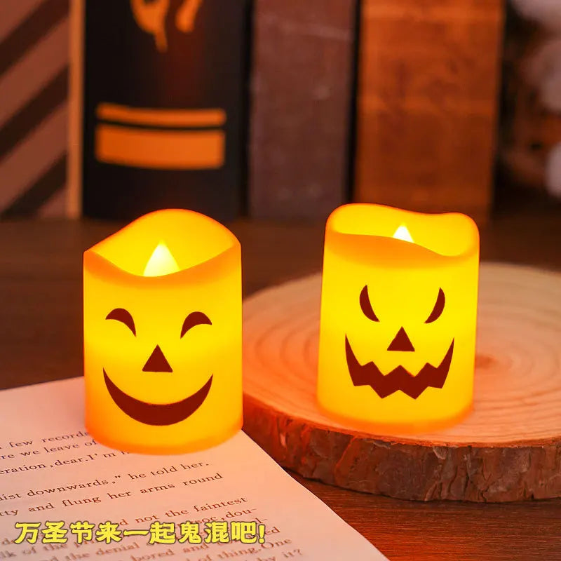 A set of six glowing orange Halloween LED candles sitting on a wooden surface.