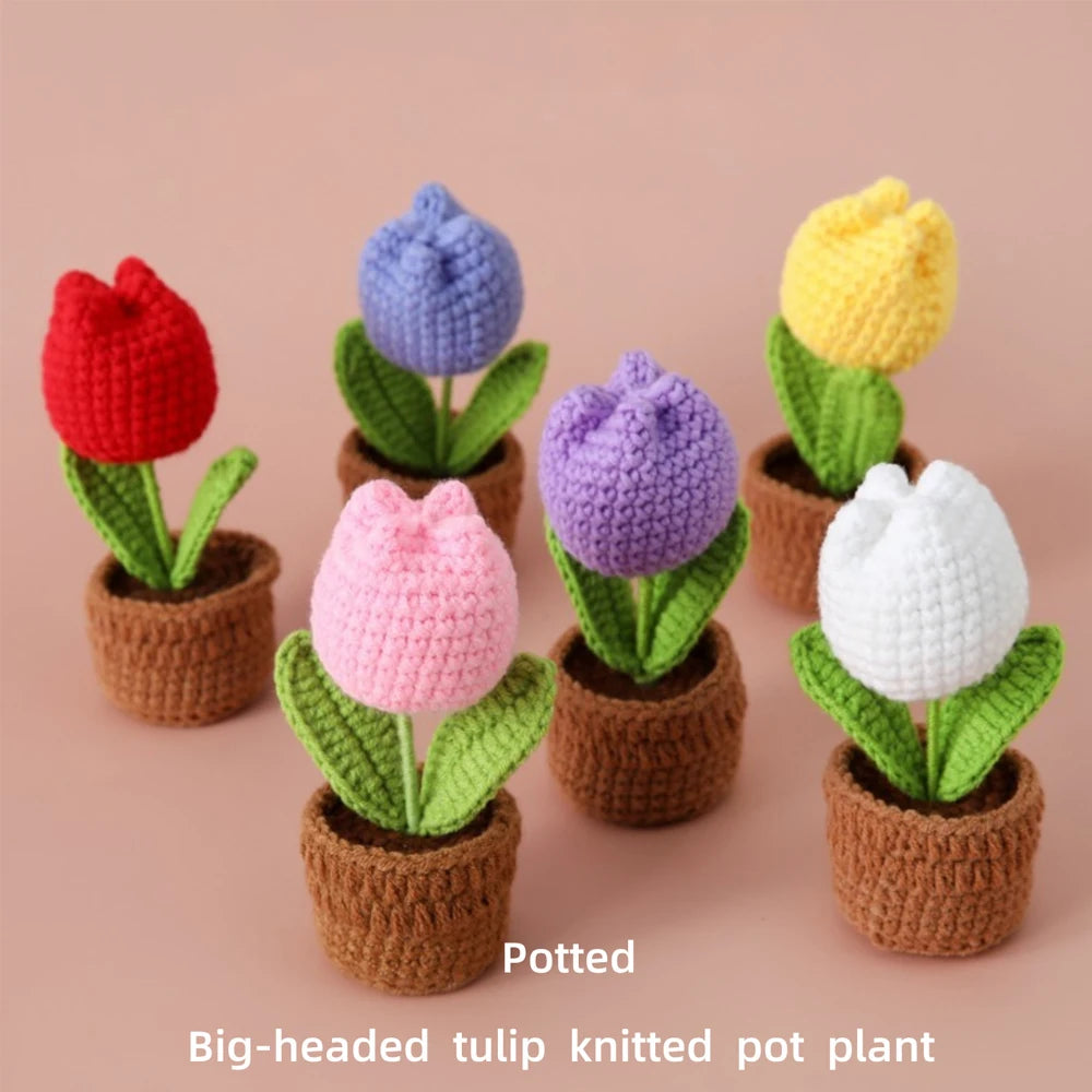 A set of handcrafted crochet tulips in brown pots with green leaves, showcasing colorful floral designs.