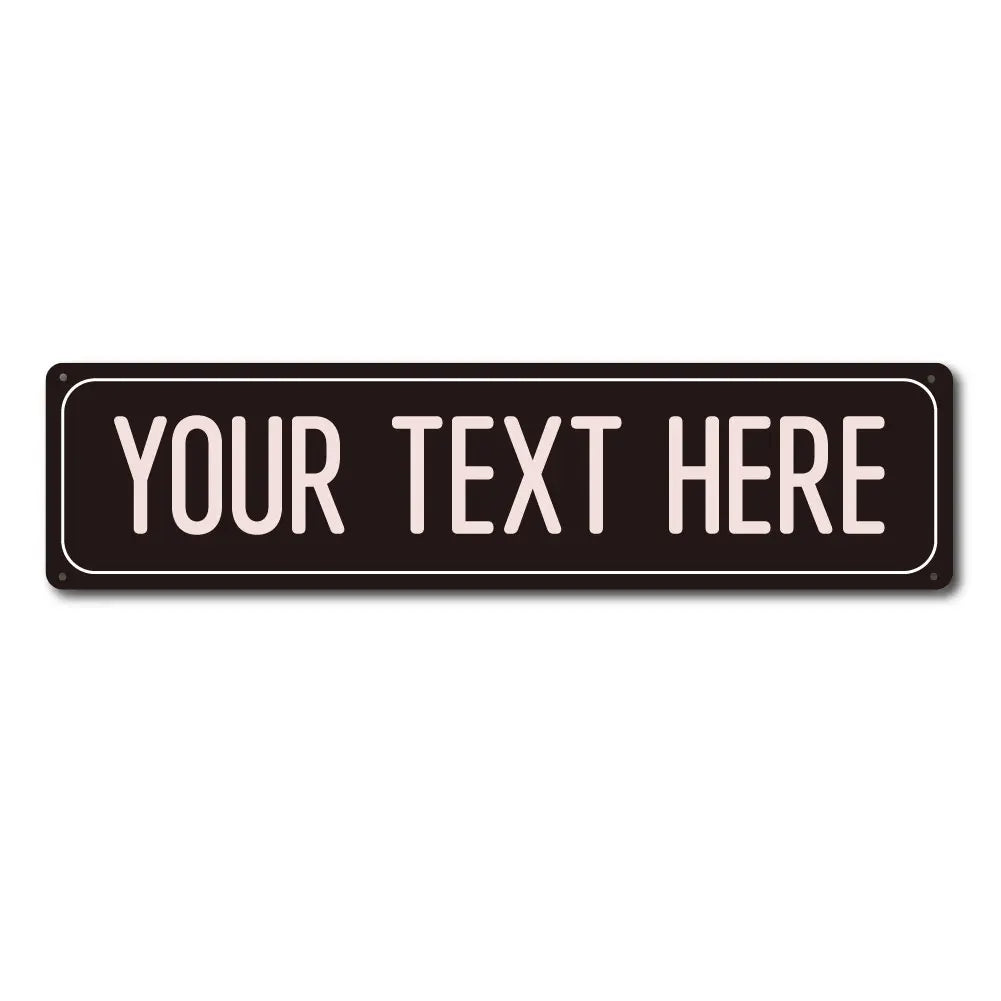 A black rectangular metal sign with the text YOUR TEXT HERE in white capital letters.
