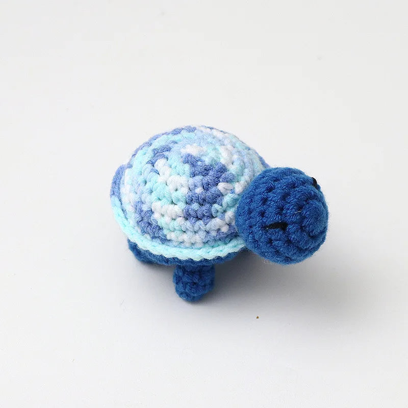 Handmade crocheted turtle plush toy in blue and white colors.