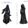 Black resin statue of a gothic female grim reaper with a flowing robe and scythe.