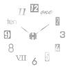 A close-up of a modern 3D acrylic wall clock showing the number twelve on the clock face.