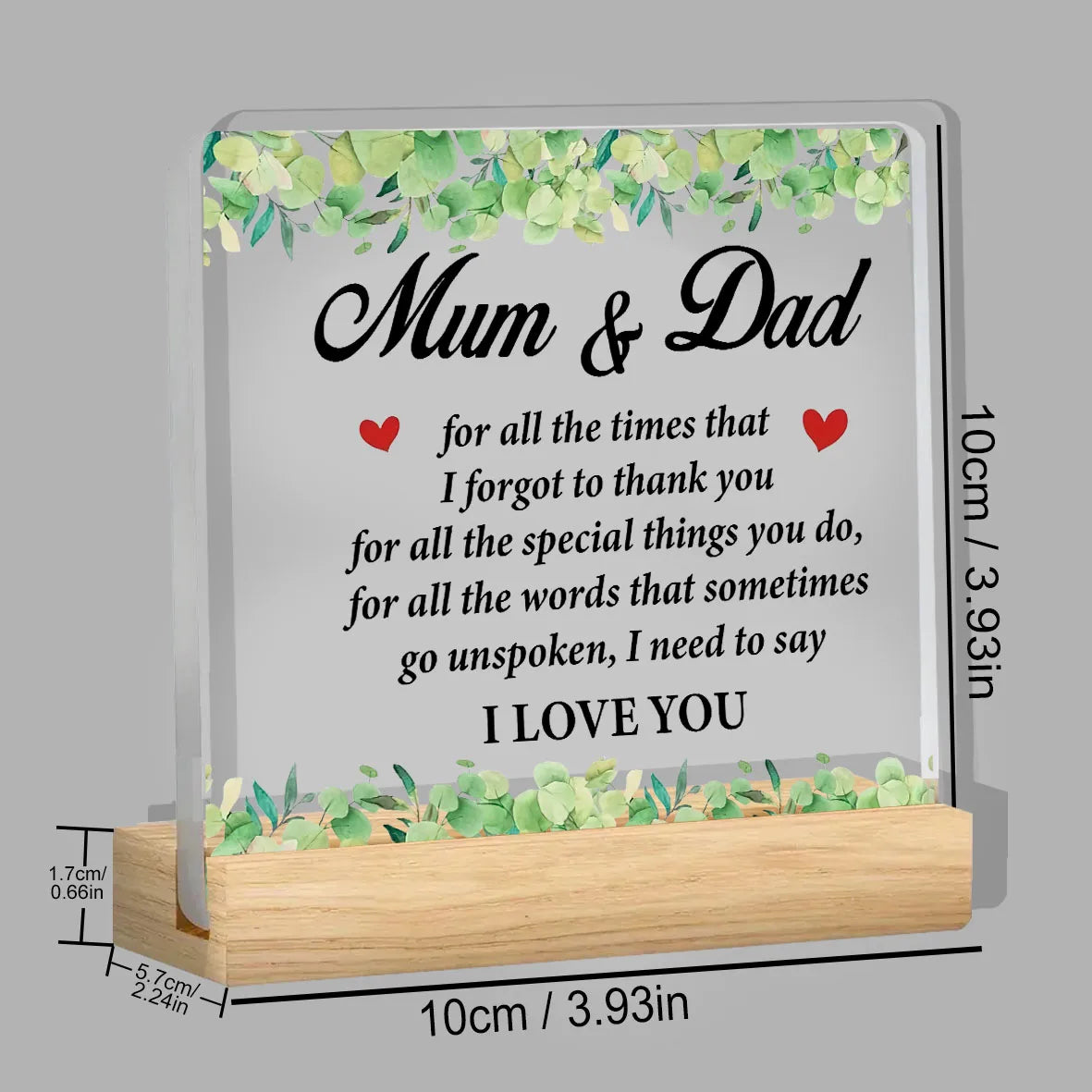 A clear acrylic plaque with the text Mum & Dad and I love you engraved on it, set in a wooden frame.