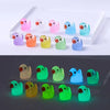A collection of luminous mini duck figurines in various pastel and bright colors arranged in a white display box.