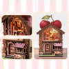 A detailed wooden layered puzzle magnet decor featuring a house with an apple tree and small garden elements.
