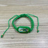 A green beaded bracelet with a rectangular pendant featuring a depiction of the Virgin Mary.