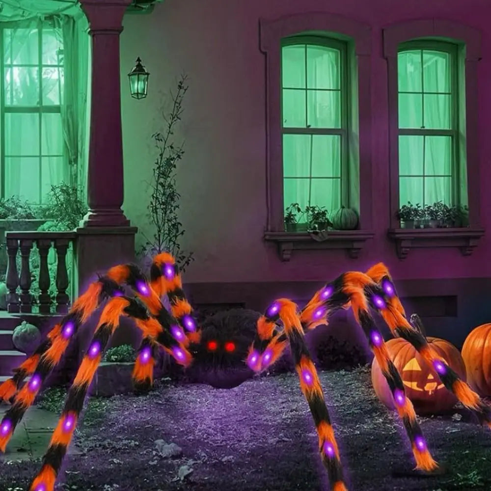 Giant spider web LED lights illuminating a porch and windows in an autumn setting.