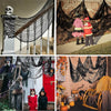 Black creepy gauze cloth draped over a wooden structure for Halloween decor