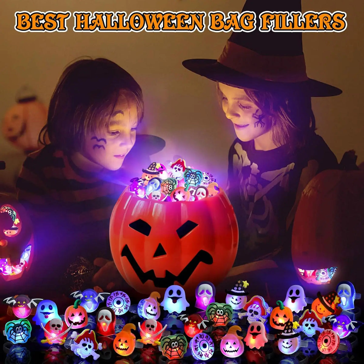 A collection of Halloween glow rings and pumpkin-themed items displayed in front of two children with carved faces.