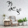 Three black dragon metal wall art panels displayed on a white brick wall next to a chair and potted plants.