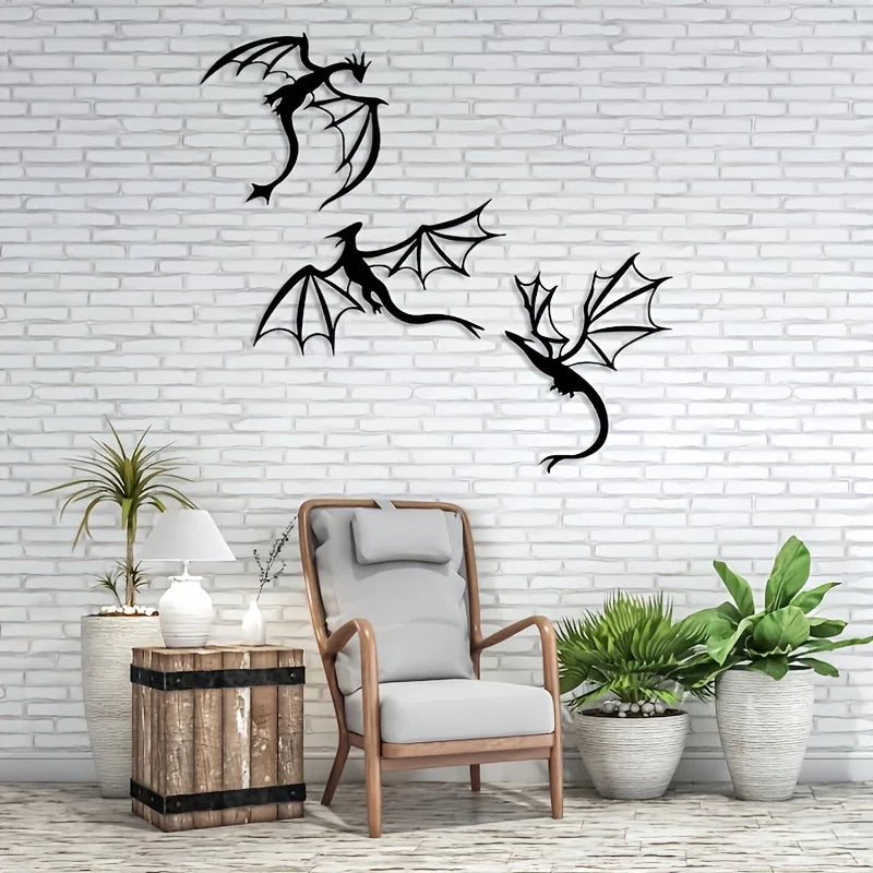 Three black dragon metal wall art panels displayed on a white brick wall next to a chair and potted plants.