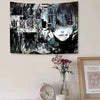 A dark, stylized anime tapestry featuring a character with intense eyes and dark hair against a moody background.