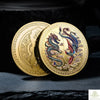 A pair of gold commemorative coins featuring Chinese dragons and phoenixes on a dark background.