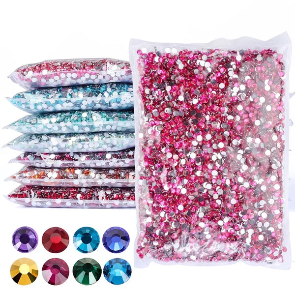 A collection of round flatback resin rhinestones in various colors and shades, including pink, purple, blue, and green.