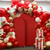 A vibrant red and gold balloon arch backdrop for an event display.