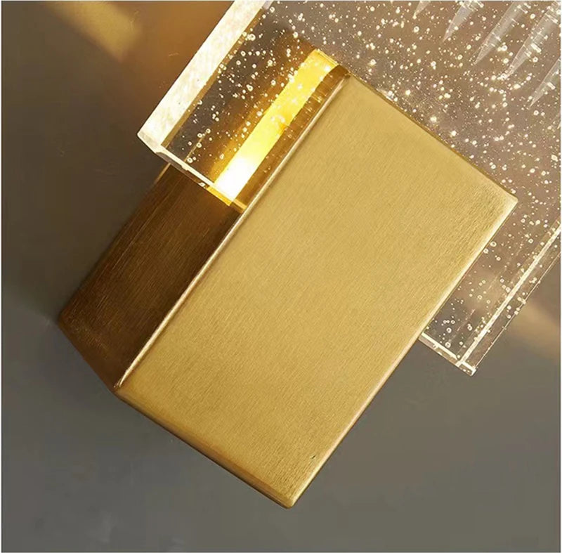 Modern bubble crystal LED wall sconces featuring gold-toned metal and sparkling clear glass.