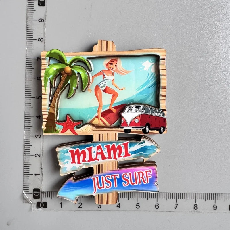 A set of fridge magnets featuring a palm tree, a woman, and text reading Miami Just Surf.