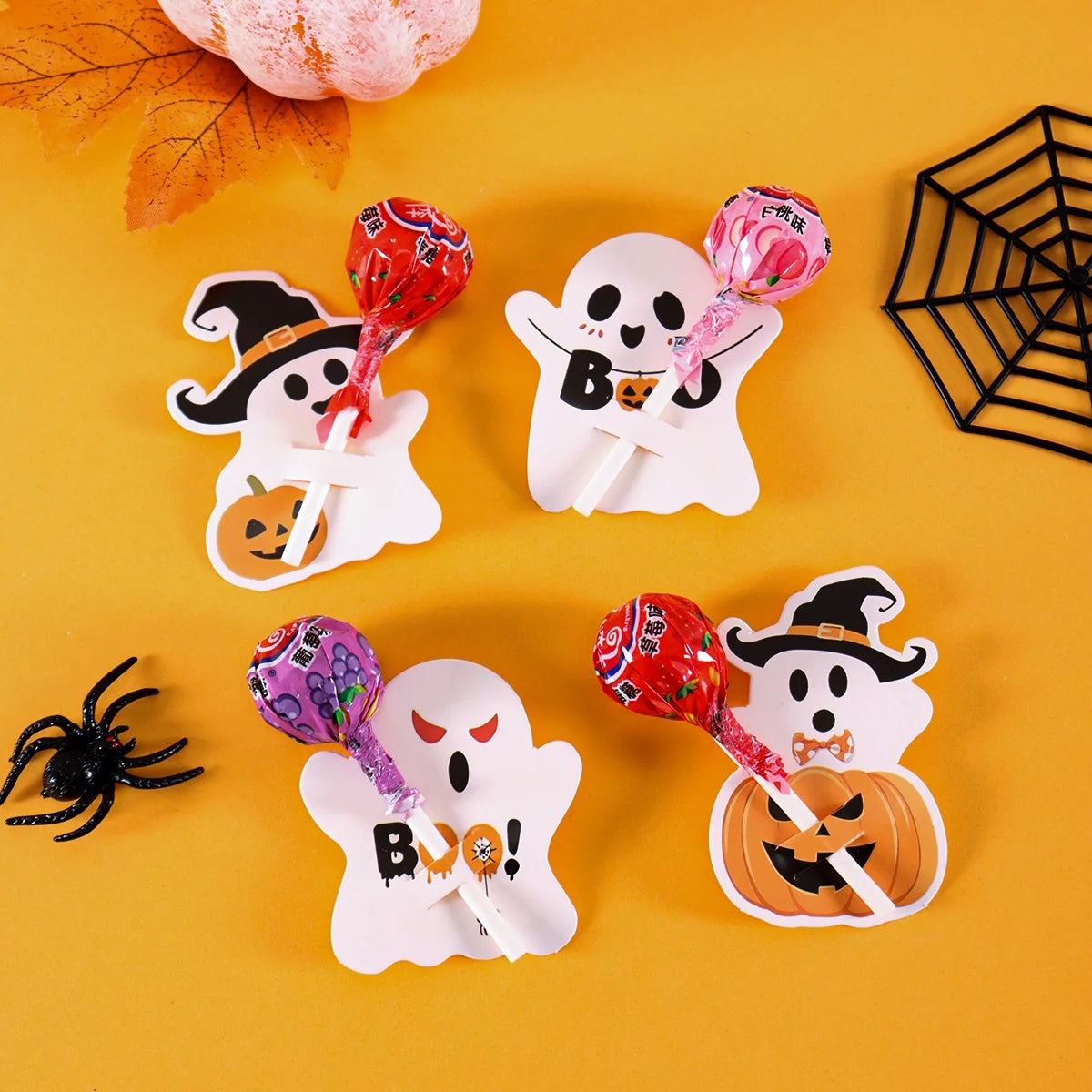 A collection of Halloween-themed lollipop holder cards featuring ghosts and witches on a yellow background.