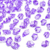 Purple decorative crushed diamond acrylic pebbles scattered on a white background